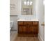 Bathroom vanity with wood cabinets, a white countertop, and a classic lighting fixture at 77 Peachtree Ne Pl # 402, Atlanta, GA 30309