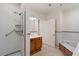 Well-lit bathroom with a walk-in shower and separate bathtub featuring a wood-paneled accent at 77 Peachtree Ne Pl # 402, Atlanta, GA 30309