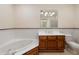 Bathroom with tiled walls, a soaking tub, and wooden vanity at 77 Peachtree Ne Pl # 402, Atlanta, GA 30309