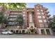 Exterior view of a well-maintained brick apartment building with multiple balconies at 77 Peachtree Ne Pl # 402, Atlanta, GA 30309