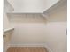 Walk-in closet with shelves, hanging rods, and hardwood floors offering ample storage space at 77 Peachtree Ne Pl # 402, Atlanta, GA 30309