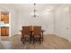 Dining area featuring a chandelier, hardwood floors, and an open doorway to the kitchen at 77 Peachtree Ne Pl # 402, Atlanta, GA 30309