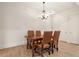 Dining area featuring a chandelier, hardwood floors, and a wood dining table with chairs at 77 Peachtree Ne Pl # 402, Atlanta, GA 30309