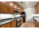 Galley kitchen featuring stainless steel appliances and wooden cabinetry at 77 Peachtree Ne Pl # 402, Atlanta, GA 30309