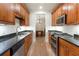 Galley kitchen with stainless appliances, wood cabinets, and granite countertops at 77 Peachtree Ne Pl # 402, Atlanta, GA 30309