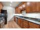 Galley kitchen with stainless appliances, wood cabinets, and granite countertops at 77 Peachtree Ne Pl # 402, Atlanta, GA 30309