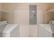 Functional laundry room with white washer and dryer units and overhead shelving at 77 Peachtree Ne Pl # 402, Atlanta, GA 30309