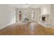 Bright living room featuring a fireplace, hardwood floors, and large windows leading to a small balcony at 77 Peachtree Ne Pl # 402, Atlanta, GA 30309