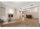 Open-concept living space featuring a fireplace, hardwood floors, and an adjacent dining area at 77 Peachtree Ne Pl # 402, Atlanta, GA 30309