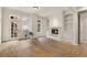 Bright living room with a fireplace, hardwood floors, and large windows leading to a small balcony at 77 Peachtree Ne Pl # 402, Atlanta, GA 30309