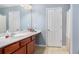 Bathroom with double vanity sink, a mirror, tile flooring and white door at 1115 Harvest Brook Ne Way, Lawrenceville, GA 30043
