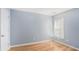Bedroom with hardwood floors, a window, a light blue wall, and a white door at 1115 Harvest Brook Ne Way, Lawrenceville, GA 30043