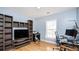 Bedroom with hardwood floors, a computer, bookshelves, and light blue walls at 1115 Harvest Brook Ne Way, Lawrenceville, GA 30043