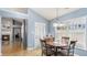 Charming breakfast nook with a round table, four chairs, and natural light from the large window at 1115 Harvest Brook Ne Way, Lawrenceville, GA 30043