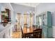 Dining area featuring a large wooden table, hardwood floors, and a view into the kitchen at 1115 Harvest Brook Ne Way, Lawrenceville, GA 30043