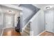 Entryway with hardwood floors, stairs to the second floor, and access to other rooms in the home at 1115 Harvest Brook Ne Way, Lawrenceville, GA 30043