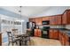 Eat-in kitchen featuring wooden cabinets, tile flooring, and modern appliances at 1115 Harvest Brook Ne Way, Lawrenceville, GA 30043