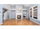 Bright living room featuring hardwood floors, fireplace, and large windows offering plenty of natural light at 1115 Harvest Brook Ne Way, Lawrenceville, GA 30043