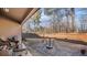 Stone patio features outdoor furniture and a grassy backyard with privacy fence at 1115 Harvest Brook Ne Way, Lawrenceville, GA 30043
