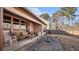 Stone patio features outdoor furniture and a grassy backyard with privacy fence at 1115 Harvest Brook Ne Way, Lawrenceville, GA 30043