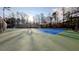 Community tennis court surrounded by trees at 1115 Harvest Brook Ne Way, Lawrenceville, GA 30043