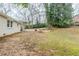 Another backyard shot showing trees and slight grading at 2504 Brentwood Rd, Decatur, GA 30032