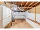 Unfinished basement space with exposed ceiling, cement floor, and hot water tank at 2504 Brentwood Rd, Decatur, GA 30032