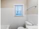 This bathroom features bright, white tile walls, and a window providing natural light at 2504 Brentwood Rd, Decatur, GA 30032