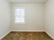 This bedroom features neutral walls, plush carpeting, and a window at 2504 Brentwood Rd, Decatur, GA 30032