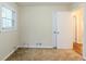 This bedroom boasts neutral walls, plush carpeting, and a window at 2504 Brentwood Rd, Decatur, GA 30032