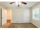 This bedroom boasts neutral walls, plush carpeting, a ceiling fan, and access to other rooms at 2504 Brentwood Rd, Decatur, GA 30032