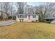 Charming single-story home with a red front door and a well-maintained lawn and partial carport at 2504 Brentwood Rd, Decatur, GA 30032