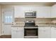 Kitchen with stainless steel appliances, granite countertops and white cabinets at 2504 Brentwood Rd, Decatur, GA 30032