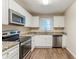 Modern kitchen featuring stainless steel appliances, granite countertops, and white cabinets at 2504 Brentwood Rd, Decatur, GA 30032