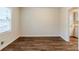 Bright living area with hardwood floors, white trim, and natural light from a window at 2504 Brentwood Rd, Decatur, GA 30032