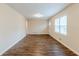 Spacious living room with hardwood floors, a window, recessed lights, and an entry door at 2504 Brentwood Rd, Decatur, GA 30032