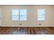 Spacious living room featuring two windows and hardwood flooring providing ample natural light at 2504 Brentwood Rd, Decatur, GA 30032