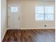 Bright room with hardwood floors, a large window, and a white paneled front door at 2504 Brentwood Rd, Decatur, GA 30032