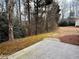Secluded backyard with mature trees and a concrete patio space at 46 Darbys Crossing Ct, Hiram, GA 30141