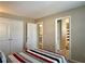 Bedroom featuring carpeted floors, tan walls, and a view into an adjacent bathroom at 46 Darbys Crossing Ct, Hiram, GA 30141