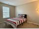 Bright bedroom with a striped comforter on a twin-sized bed and natural light from the window at 46 Darbys Crossing Ct, Hiram, GA 30141
