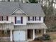Home with beige siding, maroon shutters, a gray roof, and an attached garage at 46 Darbys Crossing Ct, Hiram, GA 30141