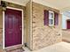 Charming brick home featuring a vibrant, paneled front door and coordinated shutters at 46 Darbys Crossing Ct, Hiram, GA 30141