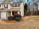 Charming home with beige siding, maroon shutters, manicured landscaping, and attached garage at 46 Darbys Crossing Ct, Hiram, GA 30141