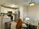Eat-in kitchen featuring white cabinets, stainless steel appliances, and a dining area with a glass table at 46 Darbys Crossing Ct, Hiram, GA 30141