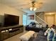 Comfortable living room featuring a ceiling fan, a staircase, and a large window with blinds at 46 Darbys Crossing Ct, Hiram, GA 30141