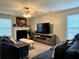 Comfortable living room with a ceiling fan, a fireplace, and a large window with blinds at 46 Darbys Crossing Ct, Hiram, GA 30141