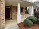 Home entrance featuring a maroon door, brick accents, and white porch columns at 46 Darbys Crossing Ct, Hiram, GA 30141
