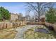Spacious backyard featuring a fire pit area, a gravel path, and a wooden fence at 726 Brookline Sw St, Atlanta, GA 30310