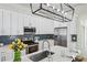 Well-equipped kitchen with white cabinetry, stainless steel appliances, and a marble countertop island at 726 Brookline Sw St, Atlanta, GA 30310